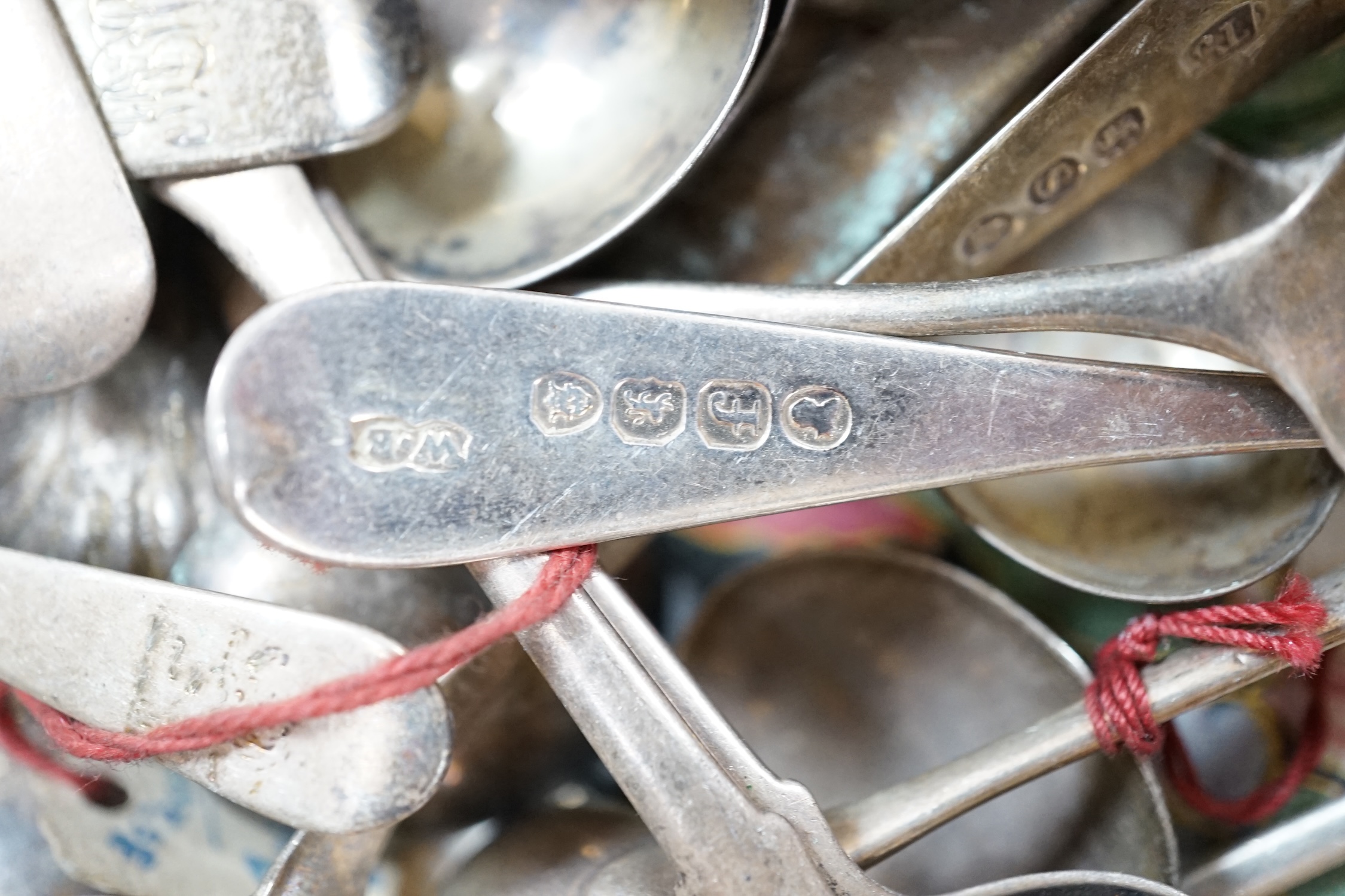 A quantity of mainly 19th century and later silver flatware, including table spoon, dessert spoons, teaspoons, condiment spoons, etc. and other items including two wine labels and a cased 9ct gold mounted amber cigarette